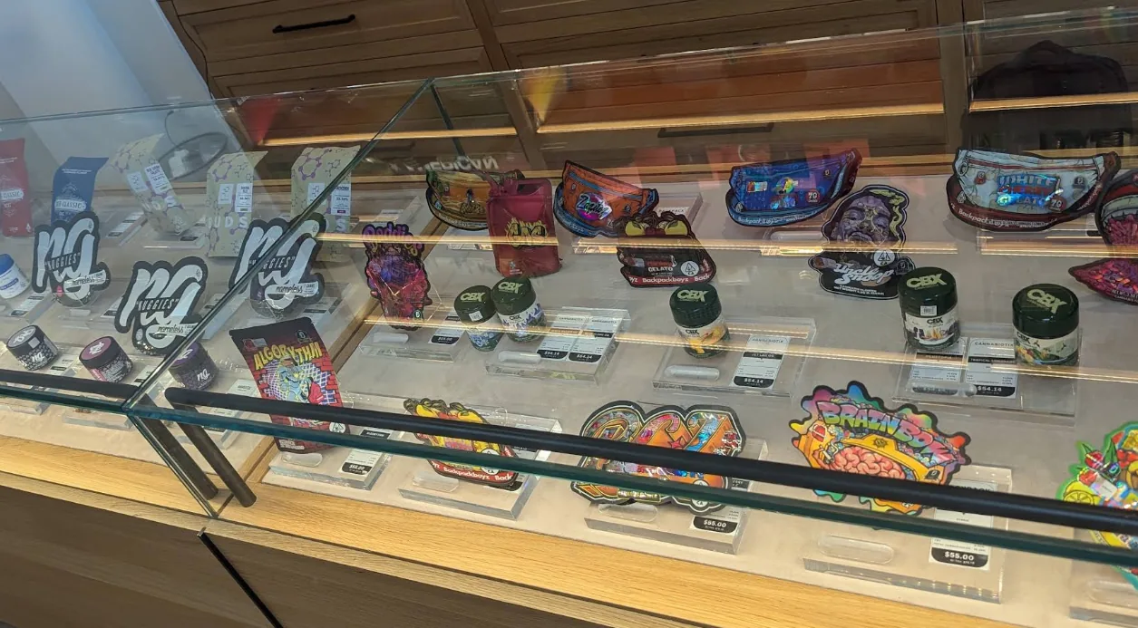 Santa Clarita Delivery 3 A flower case at Caña Beverly, mylar pouches and glass jars on a lit shelf
