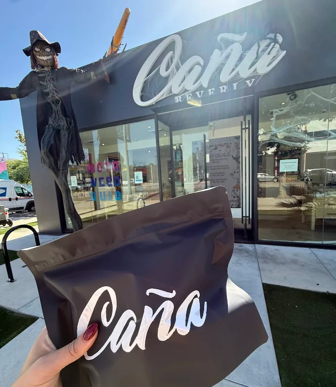 A Caña branded exit bag held up outside the Beverly store
