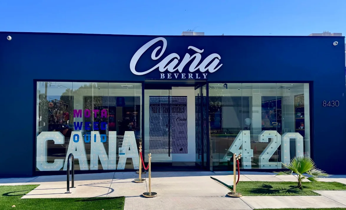 The Caña Beverly storefront in daylight, chrome sign and marquee letters in the windows