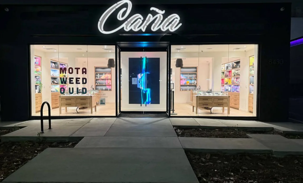 The lit Caña Beverly storefront at night on Beverly Blvd