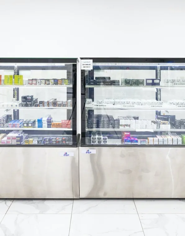 Sylmar 6 Two lit glass display cases on the sales floor at Caña Sylmar