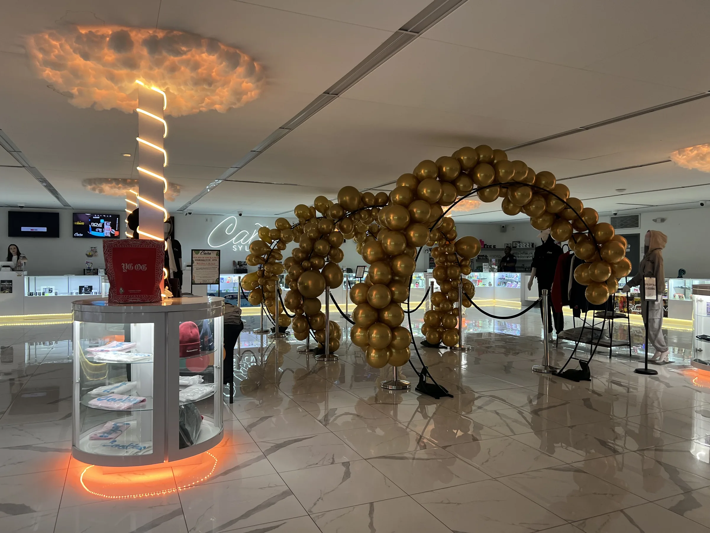 The marble showroom floor at Caña Sylmar under the neon cloud lights